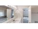 Updated bathroom with dual sinks, a large mirror, and access to the bedroom at 2530 Flippen Rd, Stockbridge, GA 30281