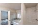 Bright bathroom with a shower-tub combo, gray tile backsplash, and natural light at 2530 Flippen Rd, Stockbridge, GA 30281