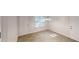 Bright dining area with wood-look floors and updated lighting, located near a window and doorway at 2530 Flippen Rd, Stockbridge, GA 30281