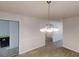 Dining area featuring modern chandelier, view to multiple rooms, and neutral paint at 2530 Flippen Rd, Stockbridge, GA 30281