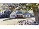 Charming one-story home featuring a covered porch, a well-maintained lawn, and mature shade trees at 2530 Flippen Rd, Stockbridge, GA 30281