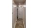 Hallway with wood-look flooring, leading to various rooms, offering a cohesive design throughout the home at 2530 Flippen Rd, Stockbridge, GA 30281
