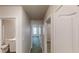 Hallway view with doorways leading to bedrooms and a bathroom with tile flooring at 2530 Flippen Rd, Stockbridge, GA 30281