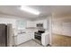 Modern kitchen with stainless appliances, white cabinets, hard surface countertops and tile flooring at 2530 Flippen Rd, Stockbridge, GA 30281