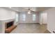 Spacious living room with a brick fireplace, multiple windows, wood-look flooring, and a ceiling fan at 2530 Flippen Rd, Stockbridge, GA 30281