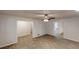 Open-concept living room with wood-look floors, neutral paint, and a ceiling fan at 2530 Flippen Rd, Stockbridge, GA 30281