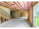 Unfinished basement with exposed framing, pink insulation, and natural light from windows at 2732 Eagles Crest Ln, Decatur, GA 30034