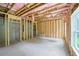 Unfinished basement with wood framing, concrete walls, and a window offering natural light at 2732 Eagles Crest Ln, Decatur, GA 30034