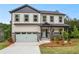 Two-story home featuring neutral siding, dark trim, inviting front porch and a two car garage at 2732 Eagles Crest Ln, Decatur, GA 30034
