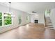 Spacious living room with hardwood floors, lots of natural light, a fireplace and adjacent staircase at 2732 Eagles Crest Ln, Decatur, GA 30034