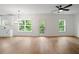 Sun-filled room with hardwood floors, modern chandelier, access to outdoor balcony and views of nature at 2732 Eagles Crest Ln, Decatur, GA 30034