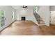 Open-concept living room featuring hardwood floors, fireplace, and a staircase leading to the upper level at 2732 Eagles Crest Ln, Decatur, GA 30034