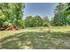 Expansive backyard featuring a playset, garden, and ample space for outdoor activities and relaxation at 3783 Wickford Ln, Peachtree Corners, GA 30096