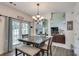 Open-concept dining area features a view of the living room and access to outdoor space at 3783 Wickford Ln, Peachtree Corners, GA 30096