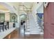 Inviting foyer featuring a staircase, hardwood floors, and a glimpse into the dining and living areas at 3783 Wickford Ln, Peachtree Corners, GA 30096