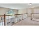 Upstairs hallway overlooking the bright foyer with view of the living room fireplace at 3783 Wickford Ln, Peachtree Corners, GA 30096