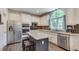 Bright kitchen with stainless steel appliances, island with seating, and granite countertops at 3783 Wickford Ln, Peachtree Corners, GA 30096