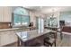 Open concept kitchen with granite counters, island seating, and view of dining area at 3783 Wickford Ln, Peachtree Corners, GA 30096