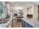 Well lit kitchen shows granite counters, island with seating, and view to dining room at 3783 Wickford Ln, Peachtree Corners, GA 30096