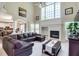 Bright and airy living room with a cozy fireplace, large windows, and modern decor at 3783 Wickford Ln, Peachtree Corners, GA 30096
