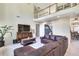 Spacious living room with tall ceilings, second-story balcony, and comfortable furniture at 3783 Wickford Ln, Peachtree Corners, GA 30096