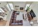 Open-concept living room with a fireplace, plush seating, and large windows for natural light at 3783 Wickford Ln, Peachtree Corners, GA 30096