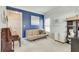 Cozy living room with blue accent wall, comfortable seating, art, and lots of natural light at 3783 Wickford Ln, Peachtree Corners, GA 30096
