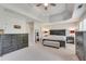 Large main bedroom with ceiling fan, tray ceiling, multiple windows, and neutral decor at 3783 Wickford Ln, Peachtree Corners, GA 30096