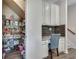 Charming pantry and desk area with gray cabinets, subway tile backsplash and granite counters at 3783 Wickford Ln, Peachtree Corners, GA 30096