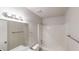 Bathroom with a shower-tub combo, contemporary fixtures, and bright vanity lighting at 765 Stonebridge Run, Lithonia, GA 30058