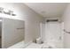 Well-lit bathroom with a shower-tub combo and modern fixtures at 765 Stonebridge Run, Lithonia, GA 30058