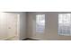 Bedroom featuring neutral walls, carpeted floors, and bright windows with blinds at 765 Stonebridge Run, Lithonia, GA 30058
