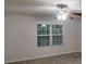 Bedroom with a ceiling fan and window providing natural light at 765 Stonebridge Run, Lithonia, GA 30058