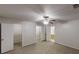 Bedroom featuring neutral carpeting, a ceiling fan, and easy access to closet and bathroom at 765 Stonebridge Run, Lithonia, GA 30058