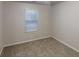 Well-lit bedroom with a window, providing natural light and carpet flooring at 765 Stonebridge Run, Lithonia, GA 30058