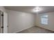 Bedroom with neutral walls, carpet flooring, and a window providing natural light at 765 Stonebridge Run, Lithonia, GA 30058