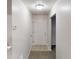 Hallway with neutral walls, carpeted floors, a white door, and access to other rooms at 765 Stonebridge Run, Lithonia, GA 30058