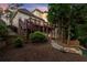 Elevated deck with stairs leading to a landscaped backyard and lush greenery at 980 Pine Grove Rd, Roswell, GA 30075