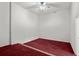 A bright bedroom with a ceiling fan and red carpet offers a relaxing space at 980 Pine Grove Rd, Roswell, GA 30075