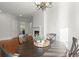 Dining area features round wood table, four chairs, and natural light at 980 Pine Grove Rd, Roswell, GA 30075