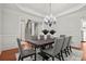 Elegant dining room with hardwood flooring, crown molding, chandelier, table and eight chairs at 980 Pine Grove Rd, Roswell, GA 30075