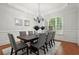 Elegant dining room with gray chairs, chandelier, large window, and crown molding at 980 Pine Grove Rd, Roswell, GA 30075