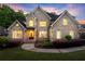 Charming two-story brick home with a well-manicured lawn and inviting curb appeal at 980 Pine Grove Rd, Roswell, GA 30075