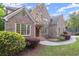 Brick home featuring beautiful landscaping, a manicured lawn, and an inviting front entrance at 980 Pine Grove Rd, Roswell, GA 30075