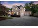 Charming two-story brick home featuring a manicured front yard and an attached two-car garage at 980 Pine Grove Rd, Roswell, GA 30075
