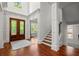 Bright foyer with hardwood flooring, a decorative front door, and staircase at 980 Pine Grove Rd, Roswell, GA 30075