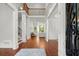 Bright foyer features hardwood floors, white trim, and stairs to the second story at 980 Pine Grove Rd, Roswell, GA 30075