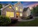 Inviting brick home featuring lush landscaping, stone accents, and large windows at 980 Pine Grove Rd, Roswell, GA 30075