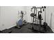 Well-equipped home gym featuring an elliptical machine and a multi-functional weight training system at 980 Pine Grove Rd, Roswell, GA 30075