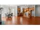 Eat-in kitchen features dark wood cabinets, large island, stainless appliances, and hardwood floors at 980 Pine Grove Rd, Roswell, GA 30075